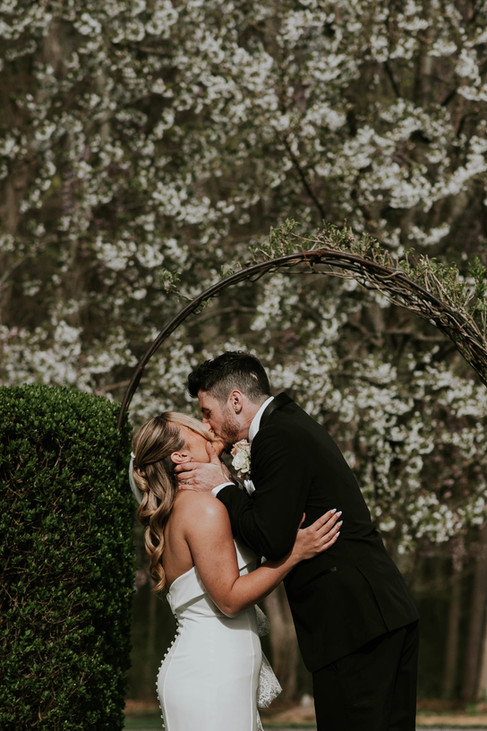 couple first kiss during wedding ceremony