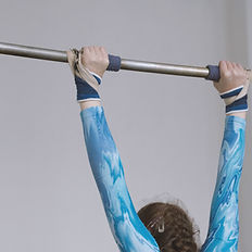 Gymnast on uneven bars, intense workout