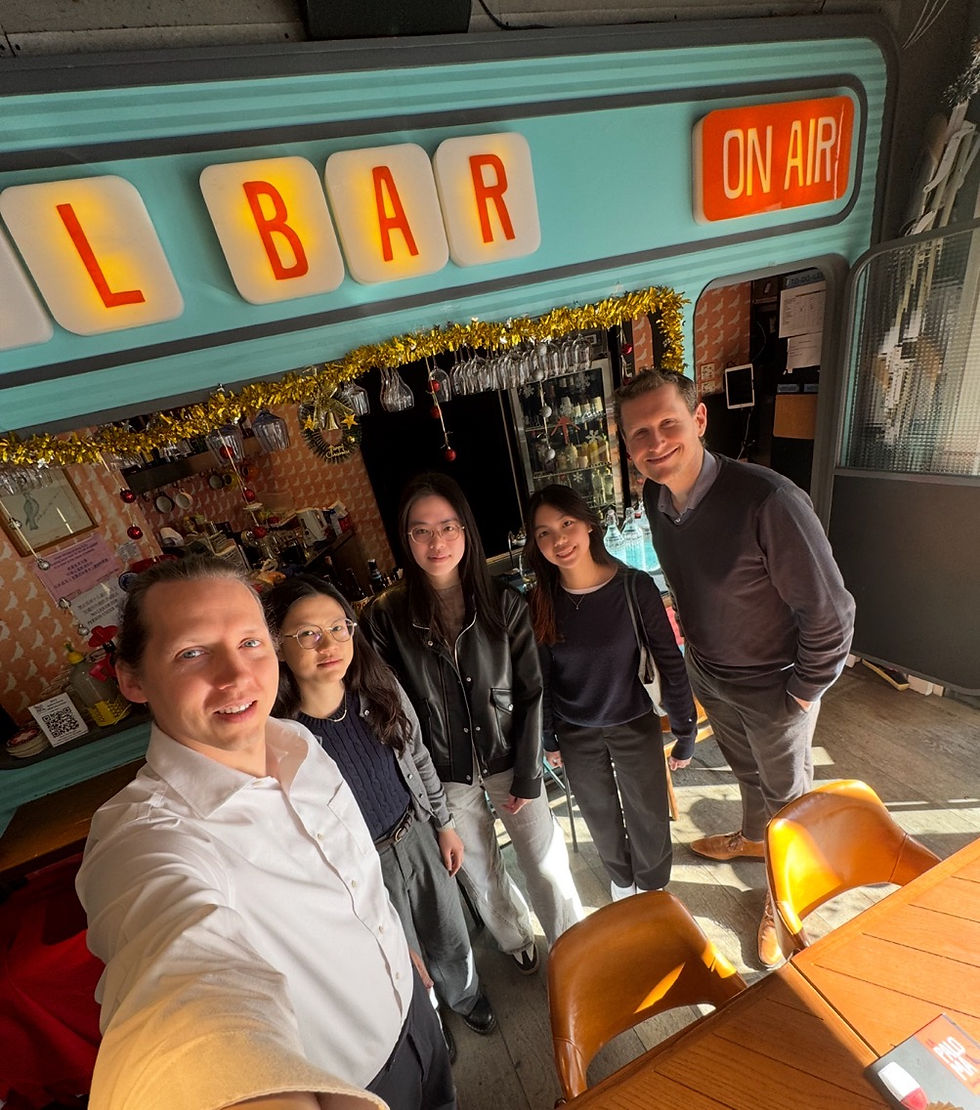 group of colleagues taking a selfie in a restaurant