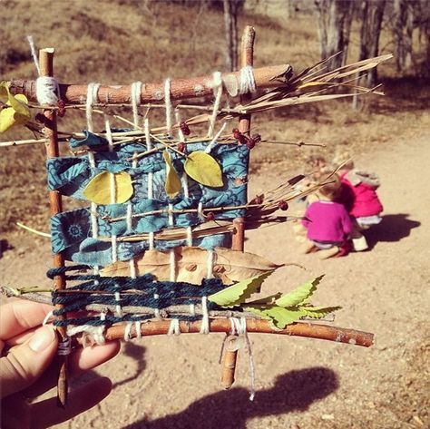 Twigs are used as a sort of "frame" for this nature weaving square, composed of leaves, scrap material, and other things found in nature