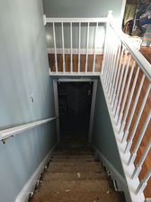 complete refresh after - stairwell from entrance/living room/railings 