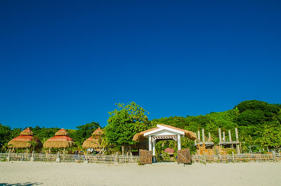 A breathtaking wide-angle shot of Calaguas White Sand Resort’s pristine beachfront, showcasing the vibrant turquoise waters a