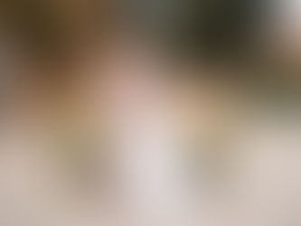 Bride and groom standing in front of an elegantly decorated reception table at a colorful château wedding in France, with a luminous and editorial atmosphere