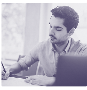 Man with laptop, paper and pen organizing family information