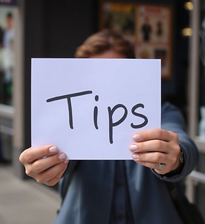 person holding out a sign that says _Tips_.jpg