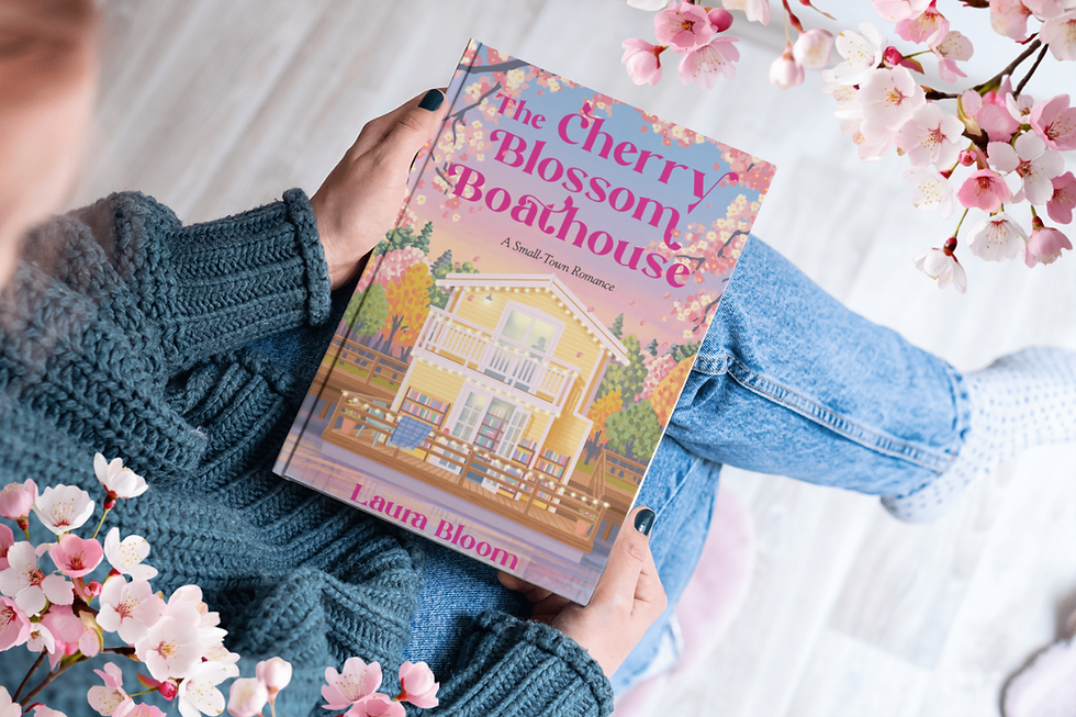 Lady holding book The Cherry Blossom Boathouse romance novel by Laura Bloom