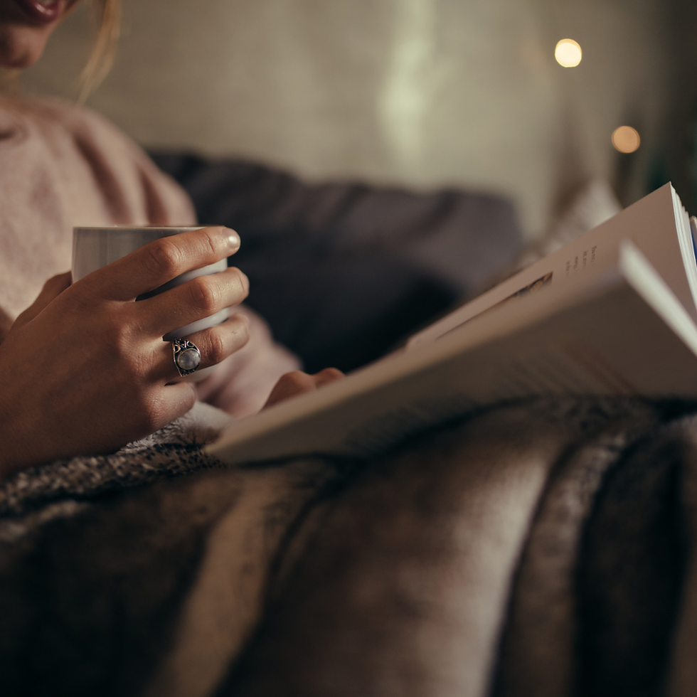 Reading a romanace novel with a cosy blanket and cup of tea