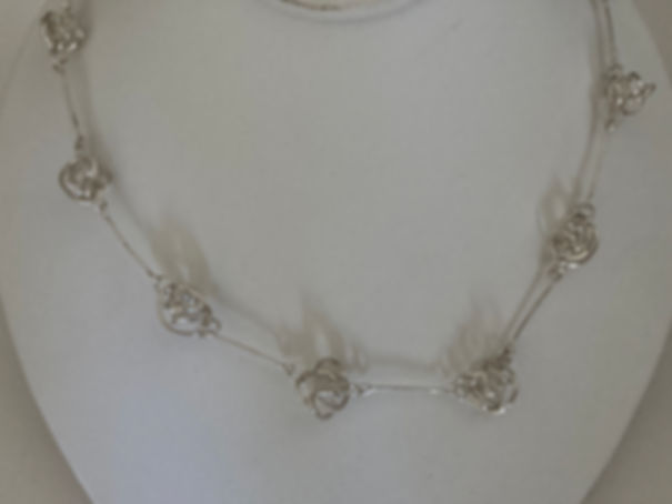 Sterling silver love knot necklace.