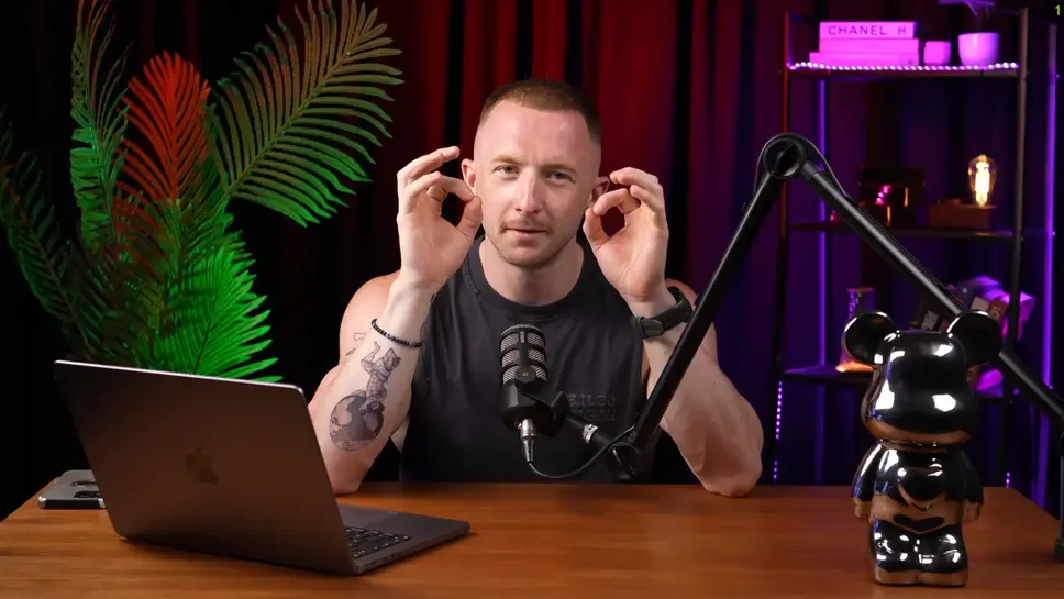 a man staring to the camera with table and laptop