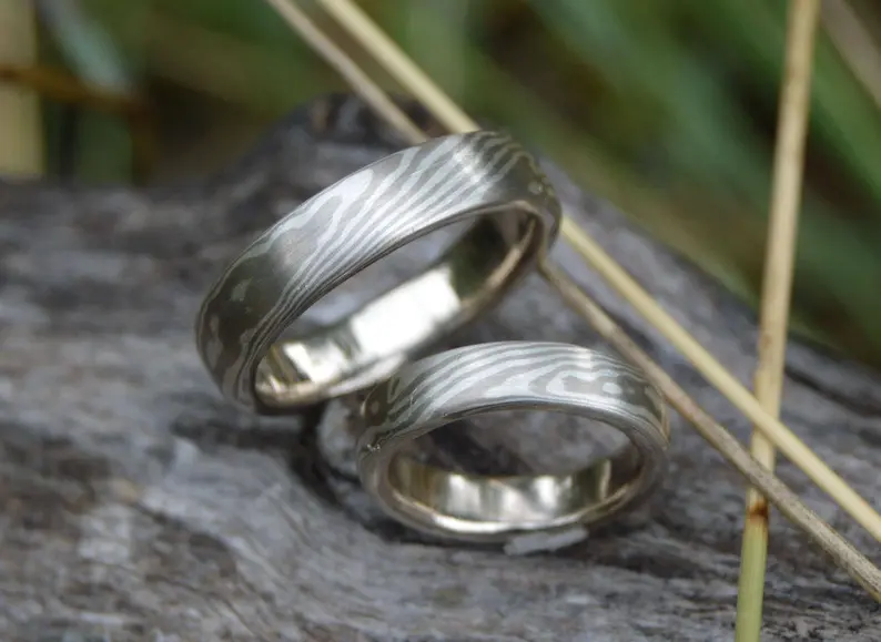 Matching wedding bands yet unique.  forged from same metal to create a set mokume gane ring set