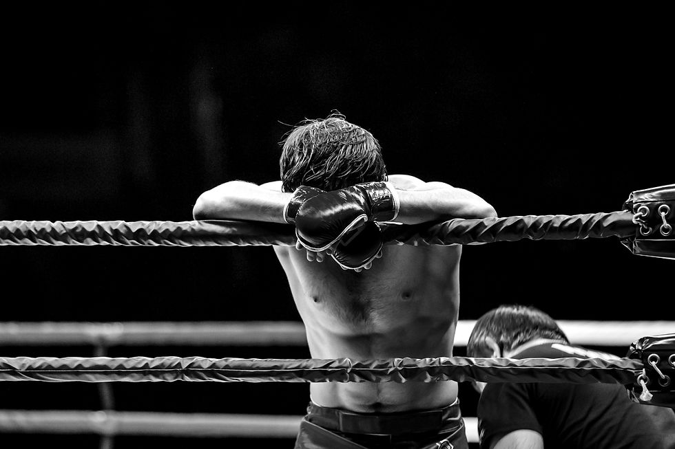Boxer Leaning on Ropes