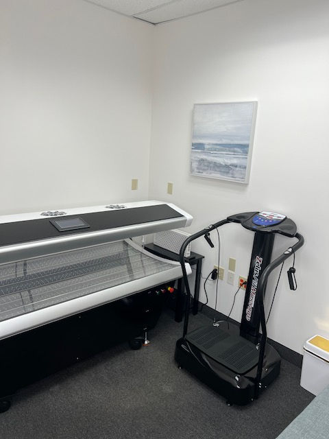 Eye-level view of a red light therapy bed glowing softly in a serene treatment room