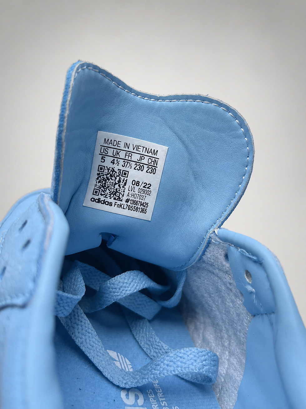 Thumbnail: Close-up of Adidas Samba OG size label and tongue tag inside Light Blue sneaker