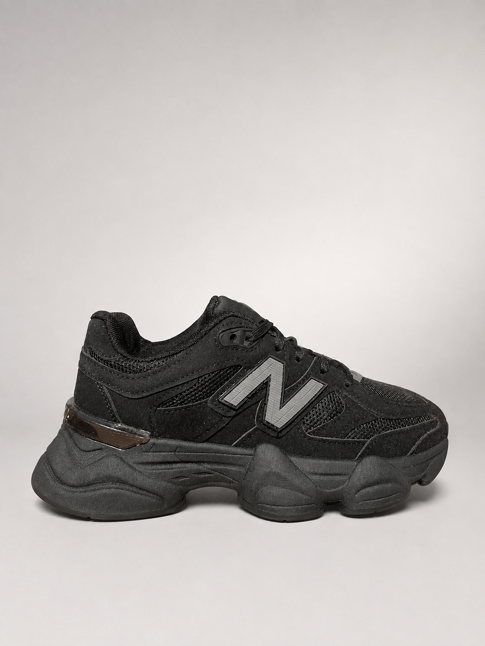 Black New Balance 9060 sneakers UK 4 side profile on light grey gradient background