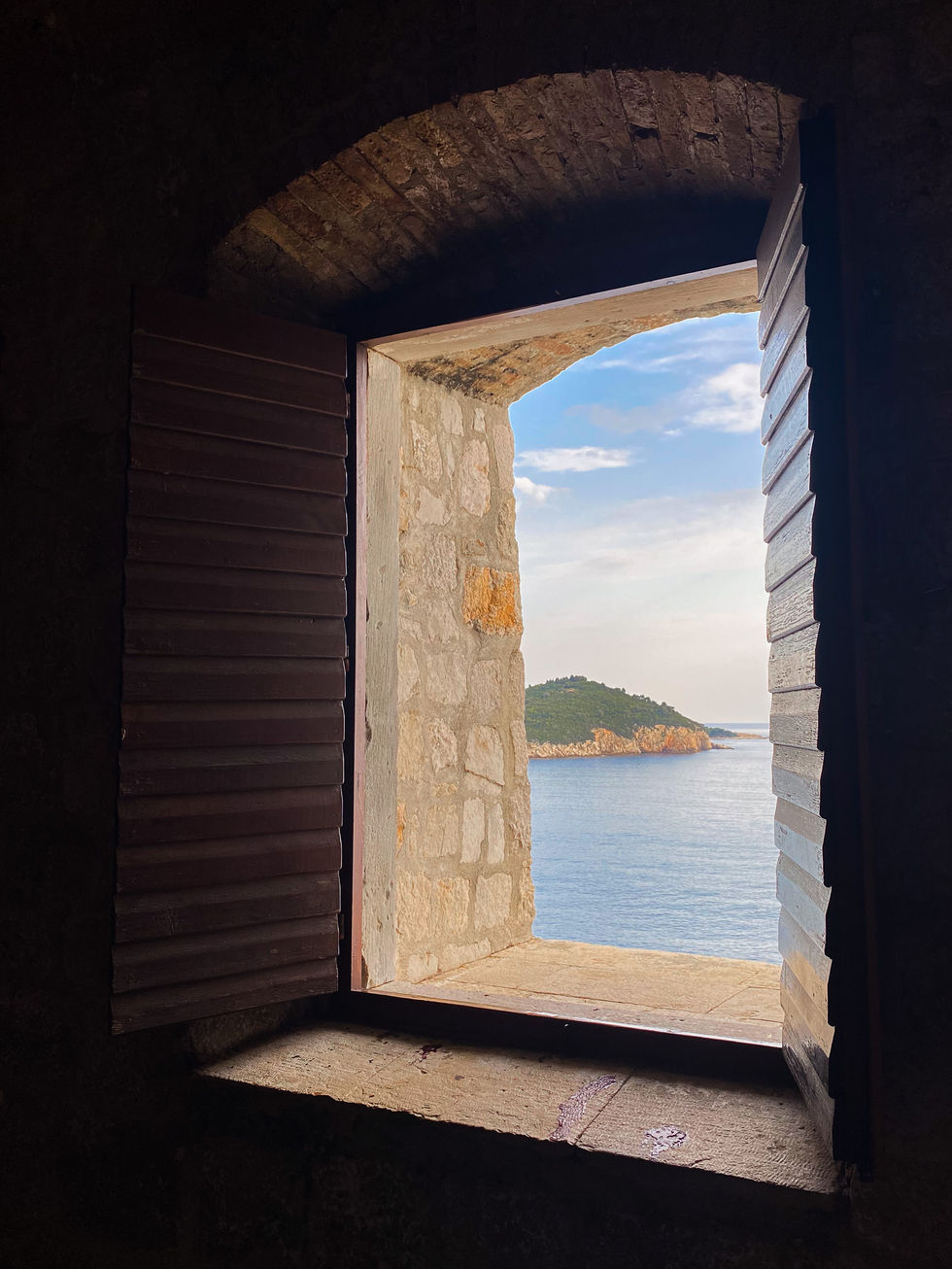 window with shutters looking out over islands in the Mediterranean Sea — travel photography by Shutter & Sojourn