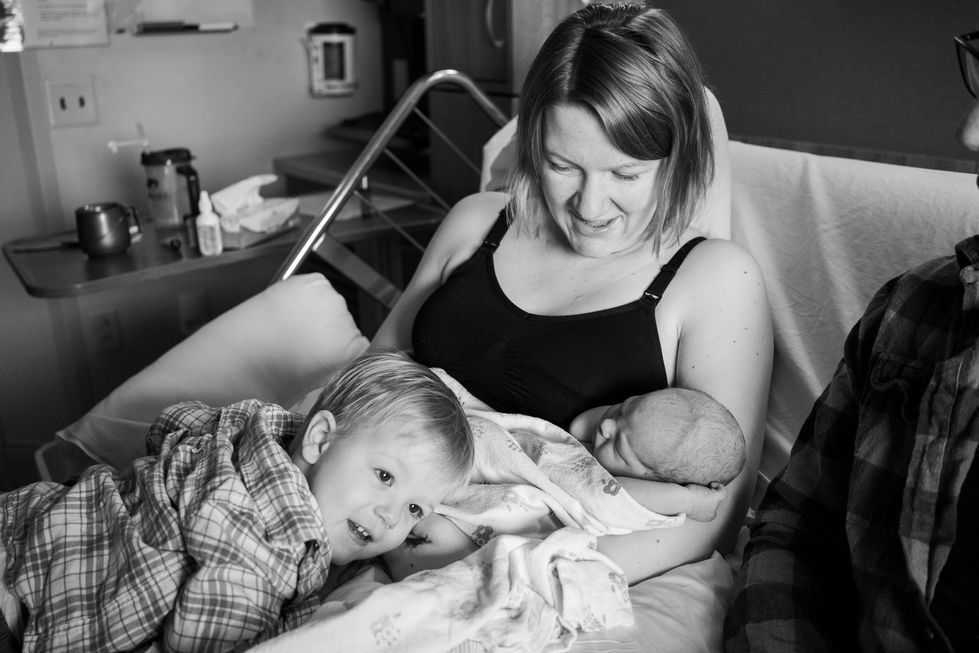 toddler hugging newborn and mom in hospital bed — newborn photography by Shutter & Sojourn