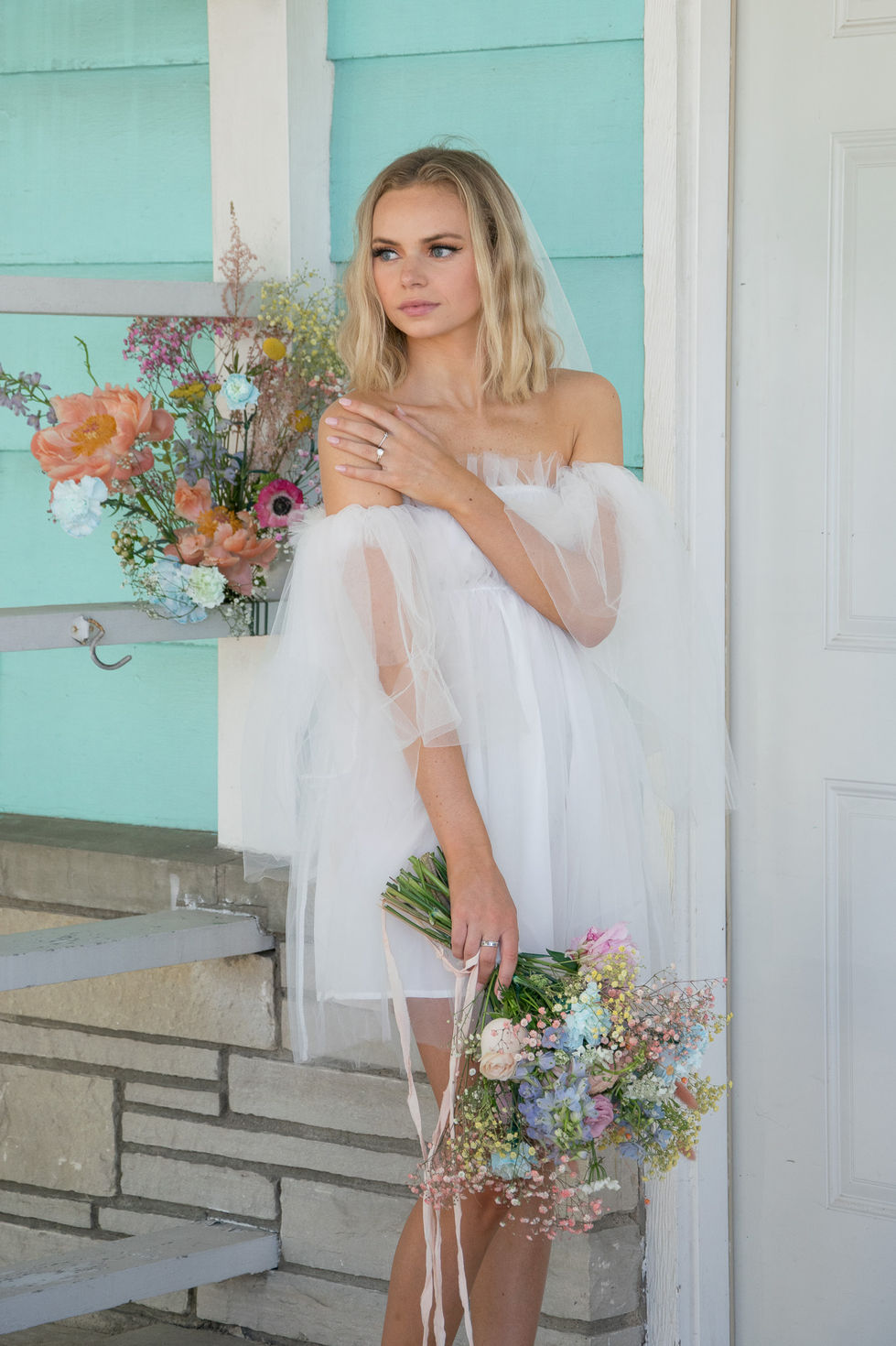 bridal portrait holding bouquet and looking into distance in door county, Wisconsin — wedding photography by Shutter & Sojourn