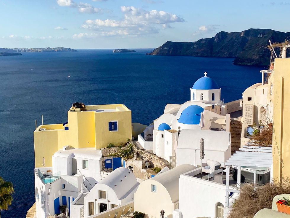 Famous white and blue Greek buildings overlooking the sea and greek islands — travel photography by Shutter & Sojourn