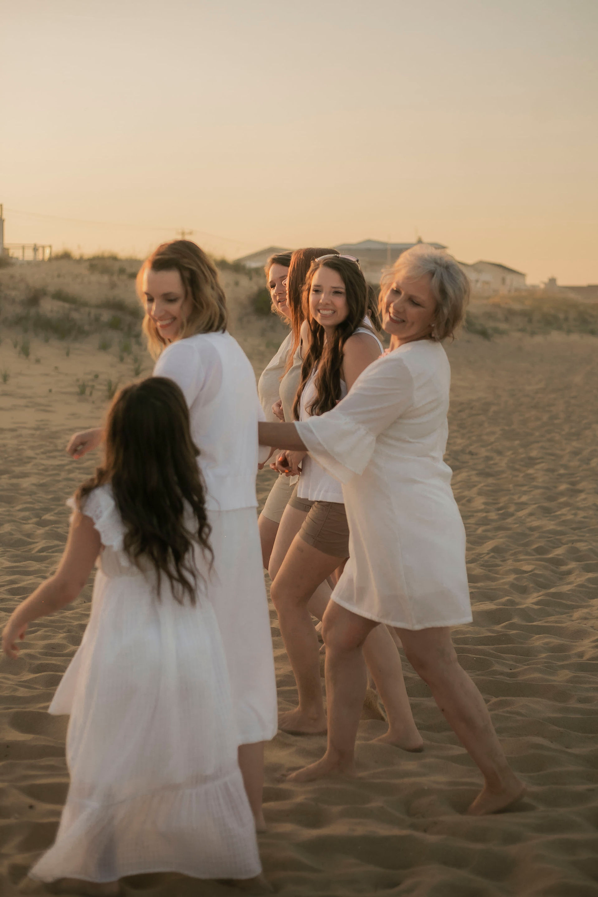 family walking on Sandbridge Beach during sunset Virginia Beach