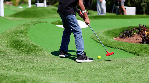 Family enjoying a luxury mini golf course at a resort-style property