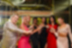 Diverse group of women toasting with drinks at an event
