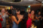 Guests cheering and celebrating at a social event.