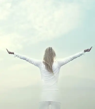 woman takes a breath in front of a blue sky