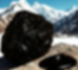 Shilajit on rock with mountain in the background