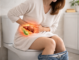 A woman sitting on a toilet with gallbladder pain