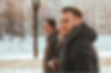 three adults outside in wintertime