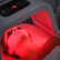 An image of a woman's face under a red light device
