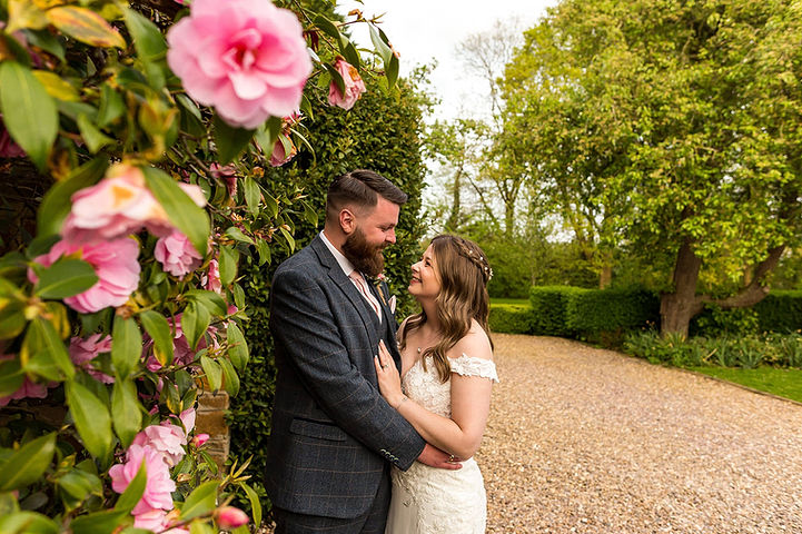 Bride and groom cuddle up together at Dodmoor House