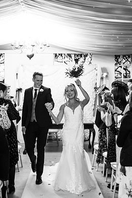 Bride and groom walk down the aisle together