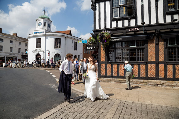 Bride and groom walking through the town of Stratford-upon-Avon