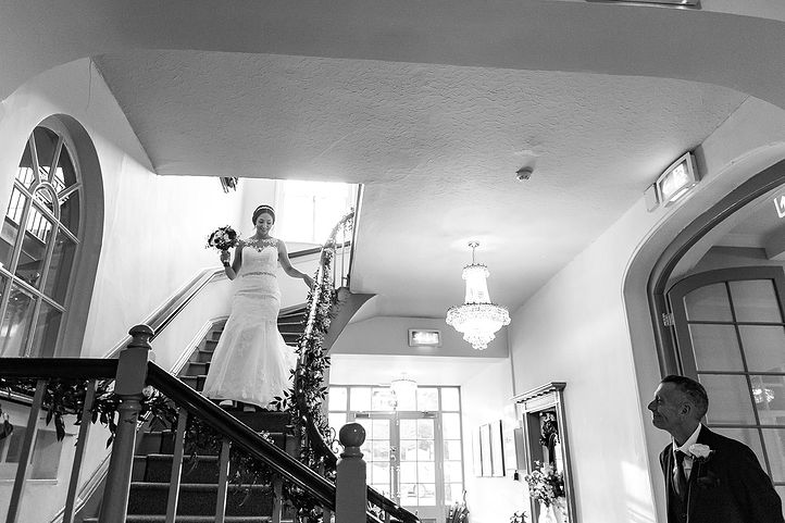 Bride walks down the stairs at Warwick House