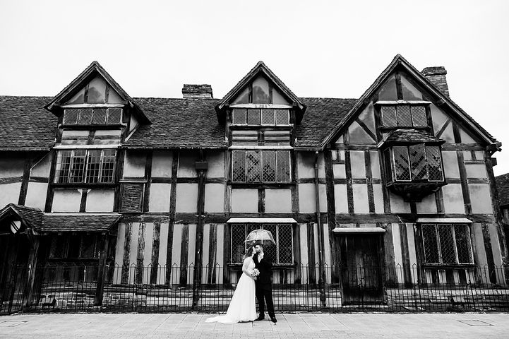 Couple pose outside the Shakespeare's Birthplace building in Stratford-upon-Avon
