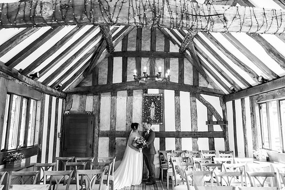 Couple kiss in The Black Prince Room at Cheylesmore Manor