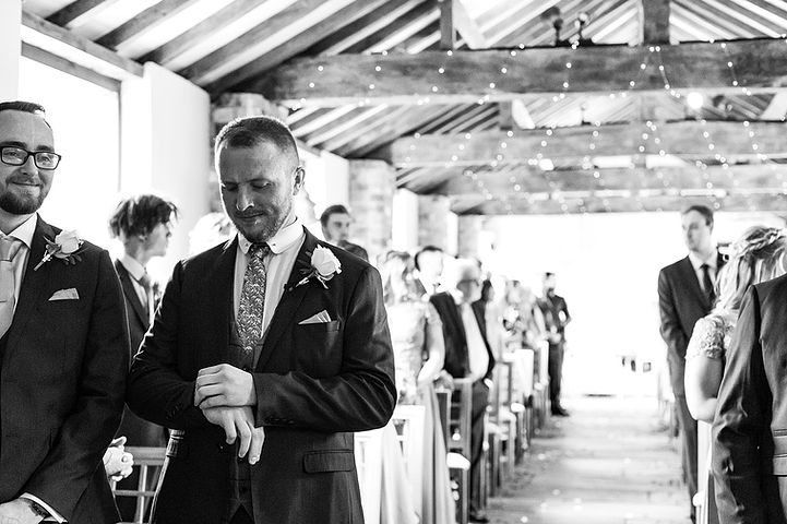Groom checks the time as he waits for his bride at Dodmoor House