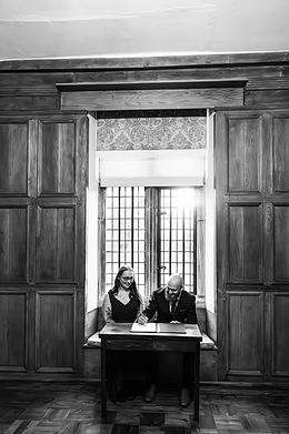 Signing the register during a ceremony at St Johns House in Warwick