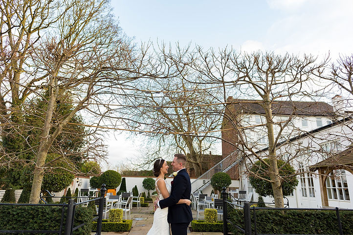 Bride and groom in the gardens at Warwick House in December