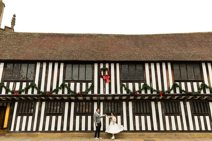 Groom spins his bride outside Shakespeare's Schoolroom & Guildhall