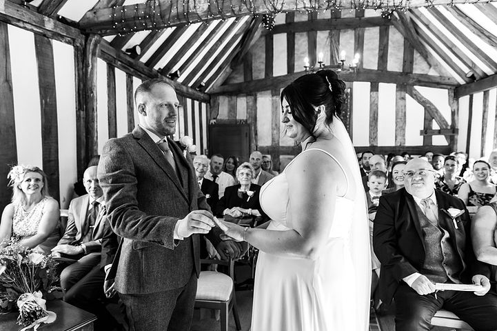 Bride and groom exchange rings in The Black Prince Room at Cheylesmore Manor