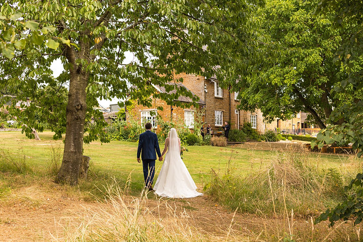 Bride and groom walk in the gardens at Crockwell Farm