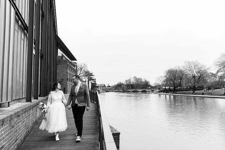 Couple walk by the river in Stratford-upon-Avon