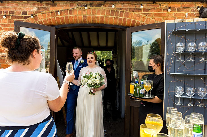 Bride and groom have welcome drinks at Dodmoor House