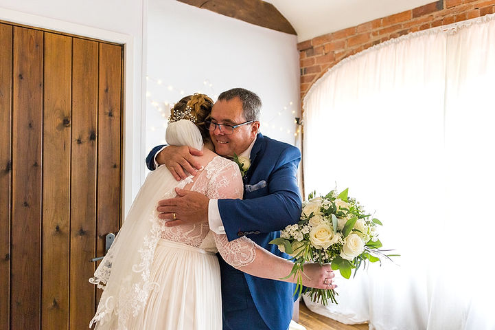 Father of the bride hugs the bride at Dodmoor House