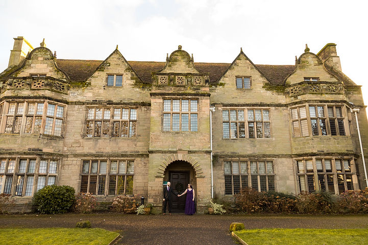 Bride and groom hold hands stood in front of St Johns House in Warwick