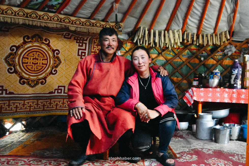 Two people sitting inside a traditional yurt. Mongolia