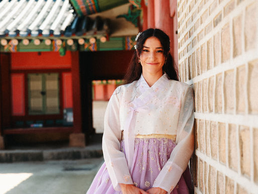 Woman in lilac coloured hanbok at Gyeongbokgung Palace in Seoul, South Korea