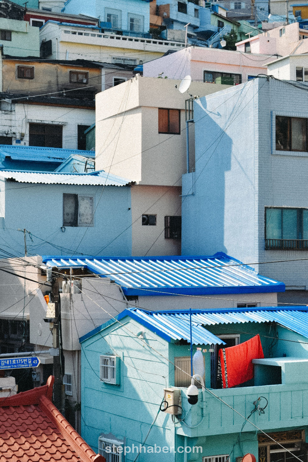 Colorful buildings with blue roofs and urban setting.